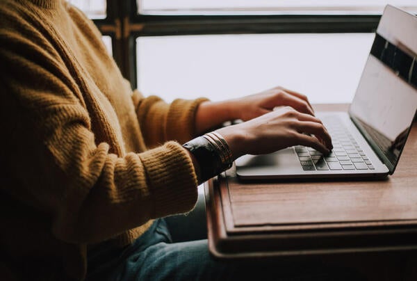 person typing on laptop computer